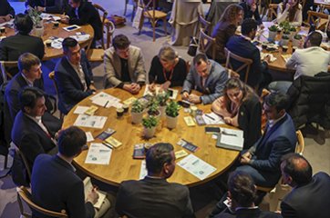 Several people at a roundtable speaking