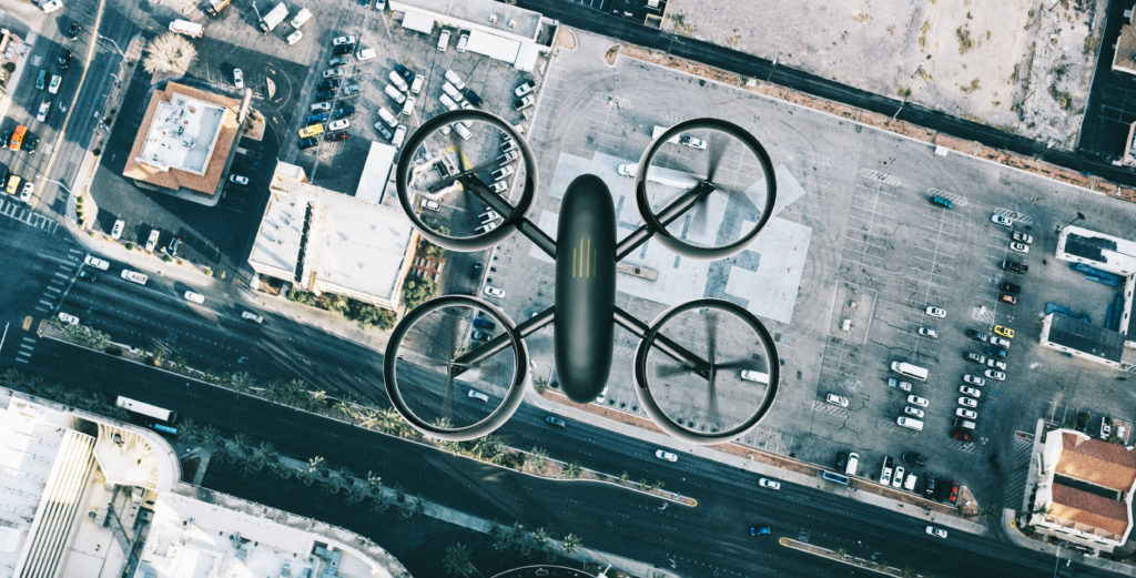 Drone on the lookout. It flys above the streets of a city looking down on buildings and streets.