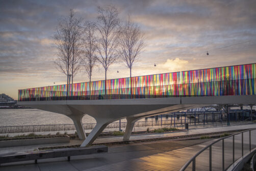 The Tide, wrapped in colour by artist Liz West, and with the Emirates Air Line cable car crossing the Thames behind.